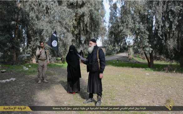 Caption: "Reading the statement of the shari'a verdict issued by the shari'a court in the province of Nineveh against a woman who committed adultery"