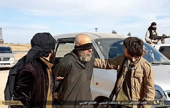 A man is led to execution for “invoking magic” in a village near Raqqa, February 2015. Photo from ISIS-affiliated social media