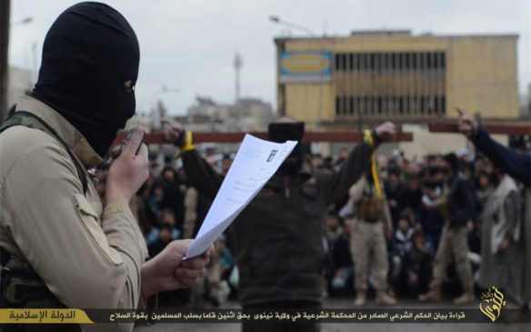 Caption: "Reading the statement of the shari'a verdict issued by the shari'a court in the state of Nineveh who robbed Muslims using the force of weapons"